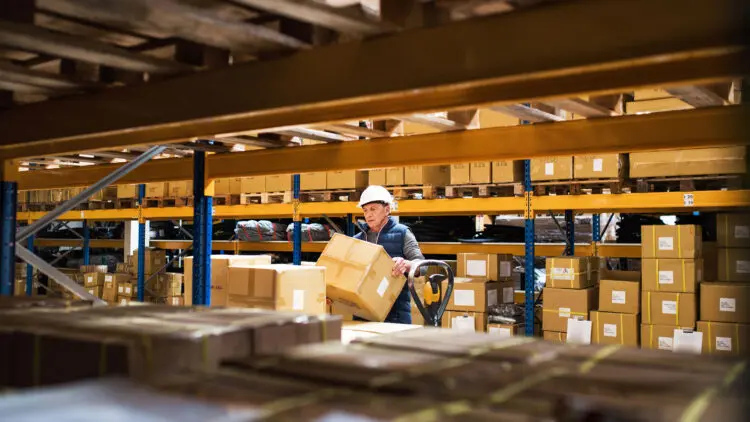 warehouse worker loading pallet truck